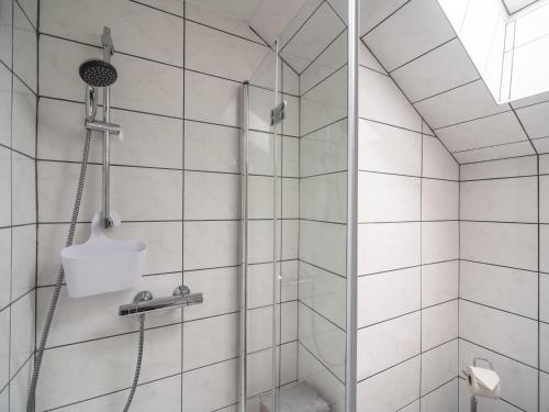 a bathroom with a shower with white tiles at Apartment in Tröpolach near Nassfeld in Tröpolach