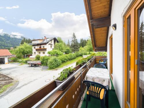 a balcony with a table and chairs and a view at Apartment in Tröpolach near Nassfeld in Tröpolach