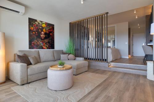 a living room with a couch and a table at Sunset Studio Mijas Costa in Sitio de Calahonda