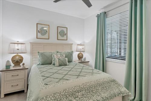 a bedroom with a bed with green curtains and a window at GRH14653 - Charlotte Harbor Area - 2 Bed 2 Baths Condo in Tropical Gulf Acres