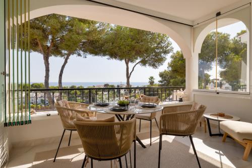 a dining room with a table and chairs on a balcony at Sunset Studio Mijas Costa in Sitio de Calahonda