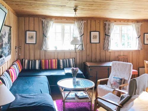 a living room with a couch and a table at 6 person holiday home in SÄVSJÖ in Nykulla