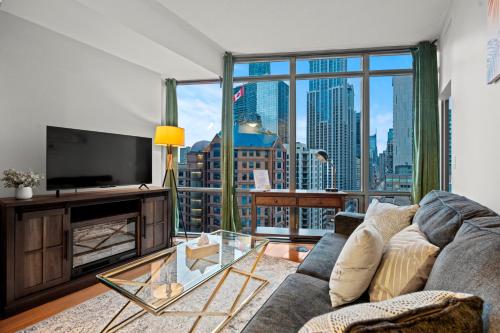 a living room with a couch and a large window at 1BR High Floor View Downtown Toronto in Toronto