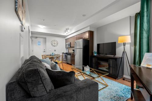 a living room with a couch and a kitchen at 1BR High Floor View Downtown Toronto in Toronto