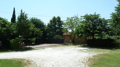 a house with a yard with trees and a driveway at Al Vecchio Leccio in Pistoia