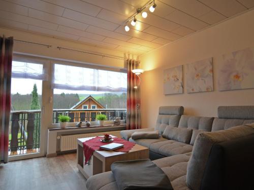 a living room with a couch and a table at Gemütliche Wohnung für 4 Personen in Medebach