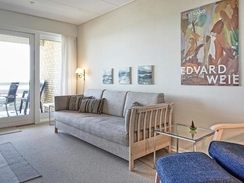 a living room with a couch and a glass table at Scenic Seaside Retreat in Sandkas-By Traum in Allinge