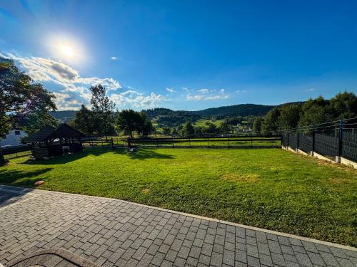 a large grassy yard with a gazebo at Beskidzki Domek Kurów in Kurów