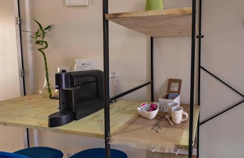 a room with a desk with a computer on a shelf at Italianflat - FREE parking, Salted Swimmingpool - Casa Ulivi del Garda in Castion Veronese