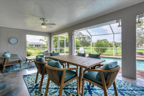 a dining room with a table and chairs and a pool at GRH14276 - Charlotte Harbor Area - 3 Bed 2 Baths Villa in Punta Gorda Isles