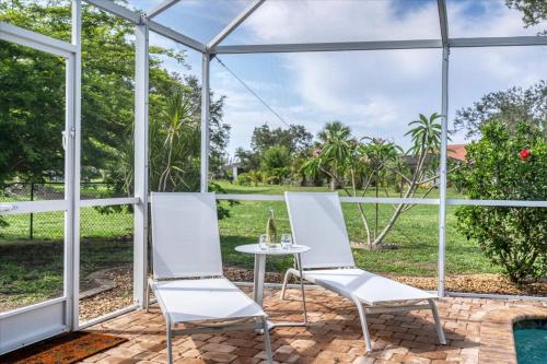 a glass house with a table and chairs on a patio at GRH14276 - Charlotte Harbor Area - 3 Bed 2 Baths Villa in Punta Gorda Isles