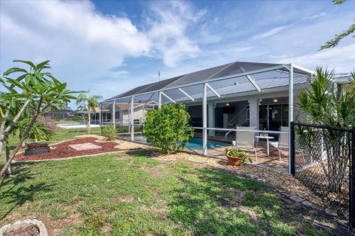 a house with a black roof and a yard at GRH14276 - Charlotte Harbor Area - 3 Bed 2 Baths Villa in Punta Gorda Isles