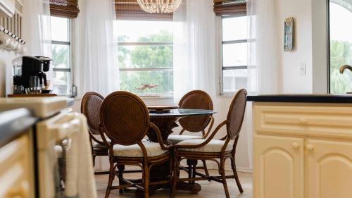 a kitchen with a table and chairs and windows at GRH11506 - Charlotte Harbor Area - 2 Bed 2 Baths Villa in Punta Gorda Isles