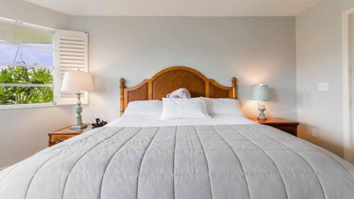 a bedroom with a large white bed and a window at GRH11506 - Charlotte Harbor Area - 2 Bed 2 Baths Villa in Punta Gorda Isles