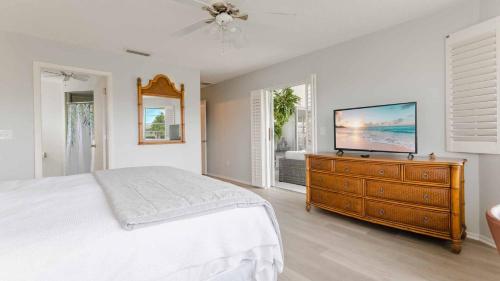a bedroom with a bed and a television on a dresser at GRH11506 - Charlotte Harbor Area - 2 Bed 2 Baths Villa in Punta Gorda Isles
