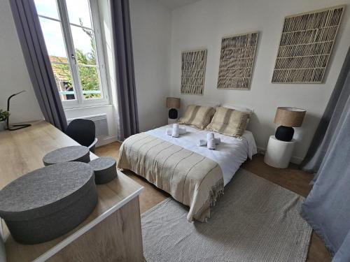 a bedroom with a bed and a large window at Chez Sandrine in Angoulême