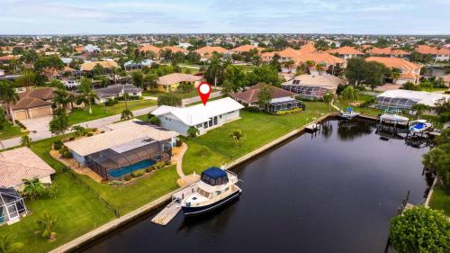 an aerial view of a house with a boat in the water at GRH11506 - Charlotte Harbor Area - 2 Bed 2 Baths Villa in Punta Gorda Isles