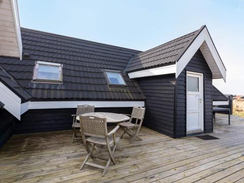 a house with a deck with a table and chairs at 6 person holiday home in Thisted-By Traum in Torsted