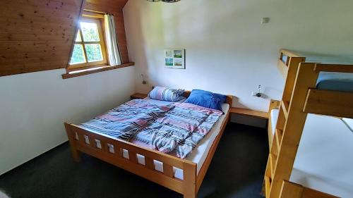 a small bedroom with a bed and a window at FerienFleckl in Warmensteinach