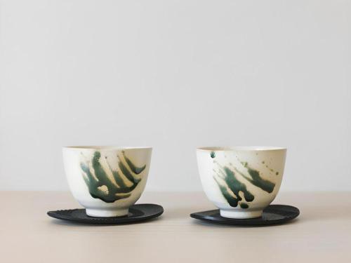 two cups sitting next to each other on a table at Hotel Yaenomidori Tokyo in Tokyo