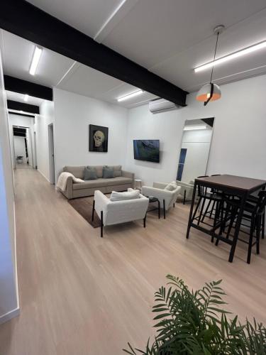a living room with a couch and a table at WEST HUB. Private Infrared Sauna near city & much more! New purpose built loft style! in Brisbane