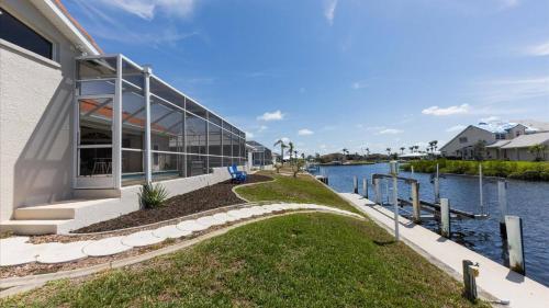 a large building next to a body of water at GRH14127 - Charlotte Harbor Area - 3 Bed 2.5 Baths Villa in Punta Gorda Isles