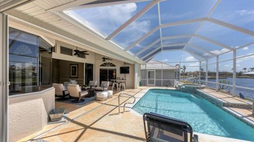 an indoor swimming pool with a glass ceiling at GRH14127 - Charlotte Harbor Area - 3 Bed 2.5 Baths Villa in Punta Gorda Isles