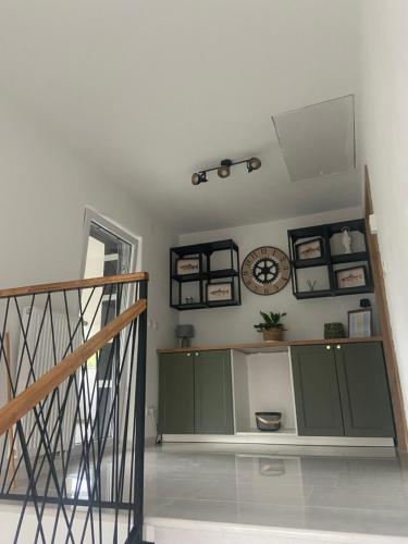 a room with a staircase and a clock on the wall at Filuma Suite with private terrace and balcony PANORAMIC GACKA VIEW in Otočac
