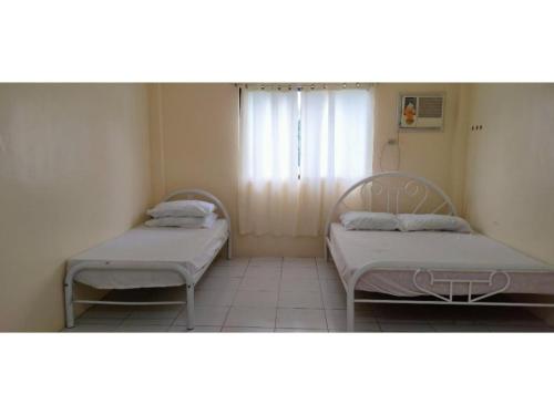Postel nebo postele na pokoji v ubytování OYO 800 DDD Habitat Dormtel Bacolod