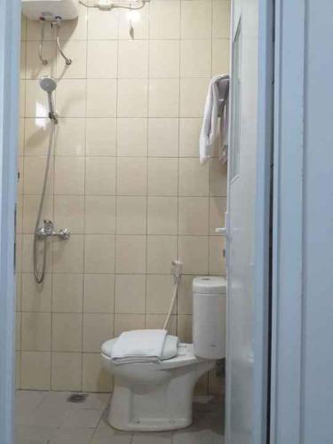 a bathroom with a toilet and a shower stall at Daima Syariah Mansion in Jakarta