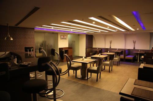 a restaurant with tables and chairs in a room at IRA By Orchid Bhubaneswar in Bhubaneshwar