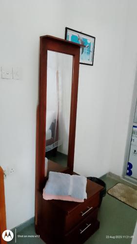 a mirror sitting on top of a dresser at Hiriketiya Lima Homestay in Dickwella