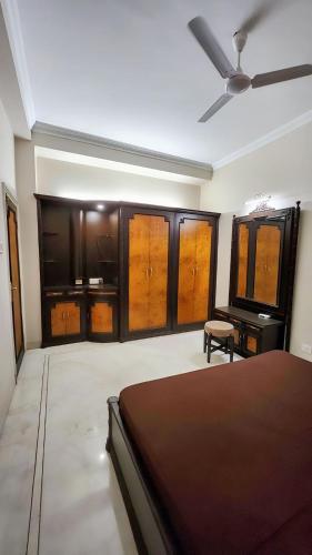 a bedroom with a bed and a ceiling fan at Nayra Apartment by Jaiswal House in Kolkata