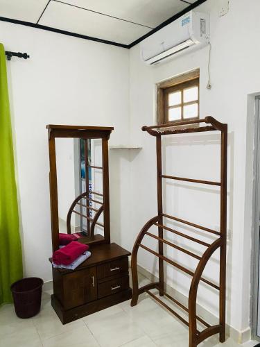 a room with two bunk beds and a mirror at Hiriketiya Lima Homestay in Dickwella