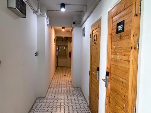 a hallway with a door and a tile floor at PG Ryoichi Hotel in Chiang Rai