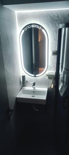 a bathroom with a white sink and a mirror at OTTO X Hotel in Kavaklıdere