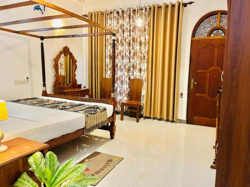 a bedroom with a bed and a mirror in it at Lucky Beach Mirissa in Mirissa