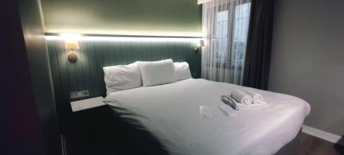 a bed in a room with two towels on it at OTTO X Hotel in Kavaklıdere