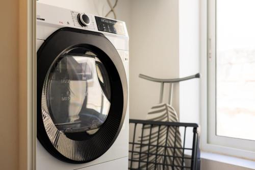a washing machine in a kitchen next to a window at Downtown Central Apartments in Msida