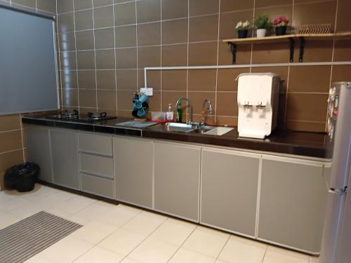 a kitchen with a sink and a counter at Homestay Kuala Selangor Islamic Friendly Only in Kuala Selangor