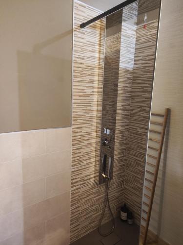 a shower in a bathroom with a glass door at La Casetta Guest House 2 in Biella