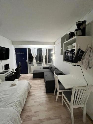 a living room with a couch and a table at Your Cozy Studio - Just Minutes from Copenhagen Airport in Copenhagen