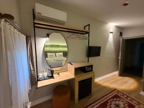 a room with a vanity with a mirror and a tv at OTTO X Hotel in Kavaklıdere