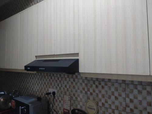 a kitchen counter top with a blue appliance on top at Apartment in Kigali
