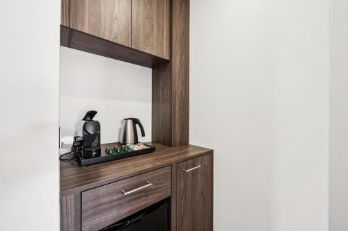 a wooden cabinet with a mirror in a room at Hotel Sonne Interlaken-Matten in Interlaken