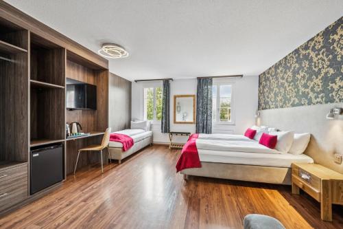 a hotel room with a bed and a desk at Hotel Sonne Interlaken-Matten in Interlaken