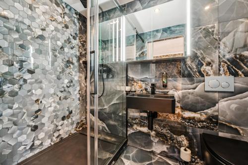 a bathroom with a sink and a shower at Hotel Sonne Interlaken-Matten in Interlaken