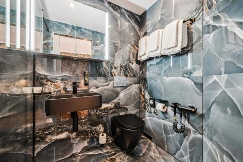a bathroom with a sink and a toilet at Hotel Sonne Interlaken-Matten in Interlaken