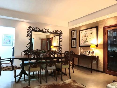 a dining room with a table and a mirror at 29 on St James Guest Lodge in Durban