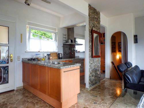 a kitchen with a island in the middle of a room at Casa Laluni in Porto Valtravaglia